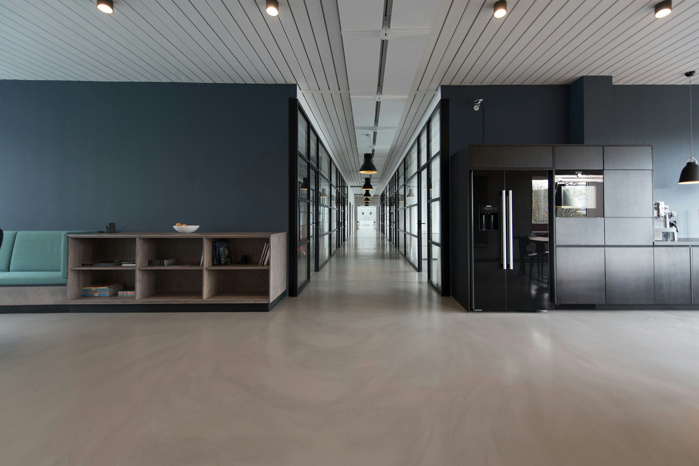 Modern open-plan commercial office interior with linear lighting