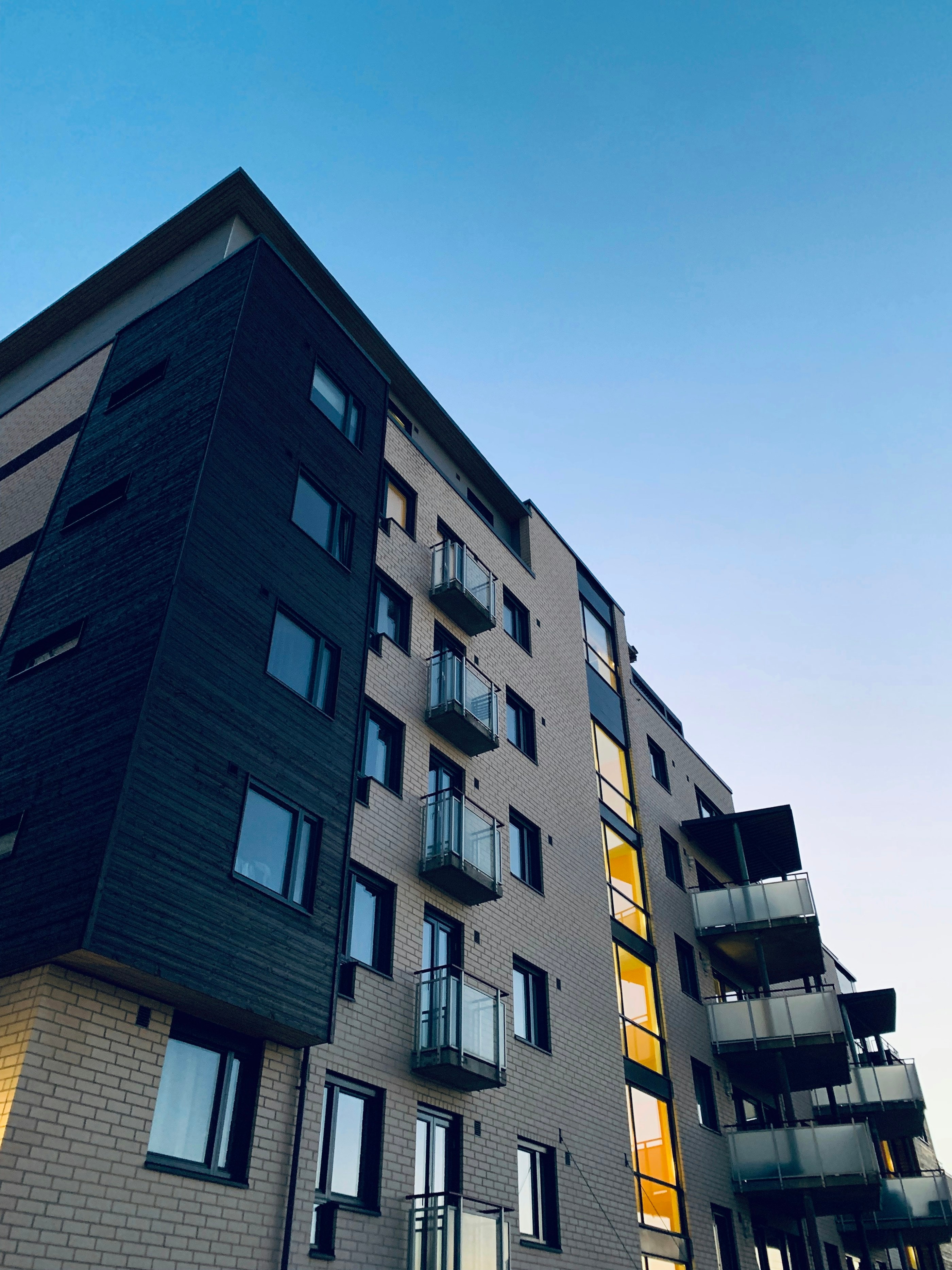 Contemporary residential apartment building with podium glazing